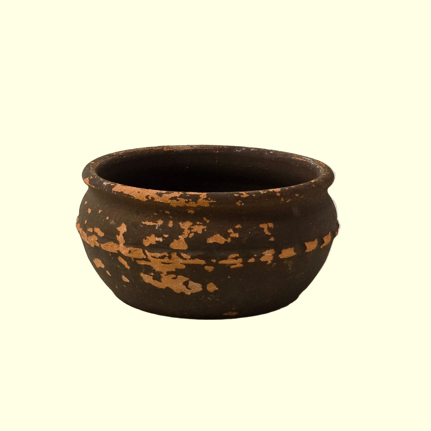 A dark green, ceramic Italian planter pot with a rustic aged patina and weathered textures.