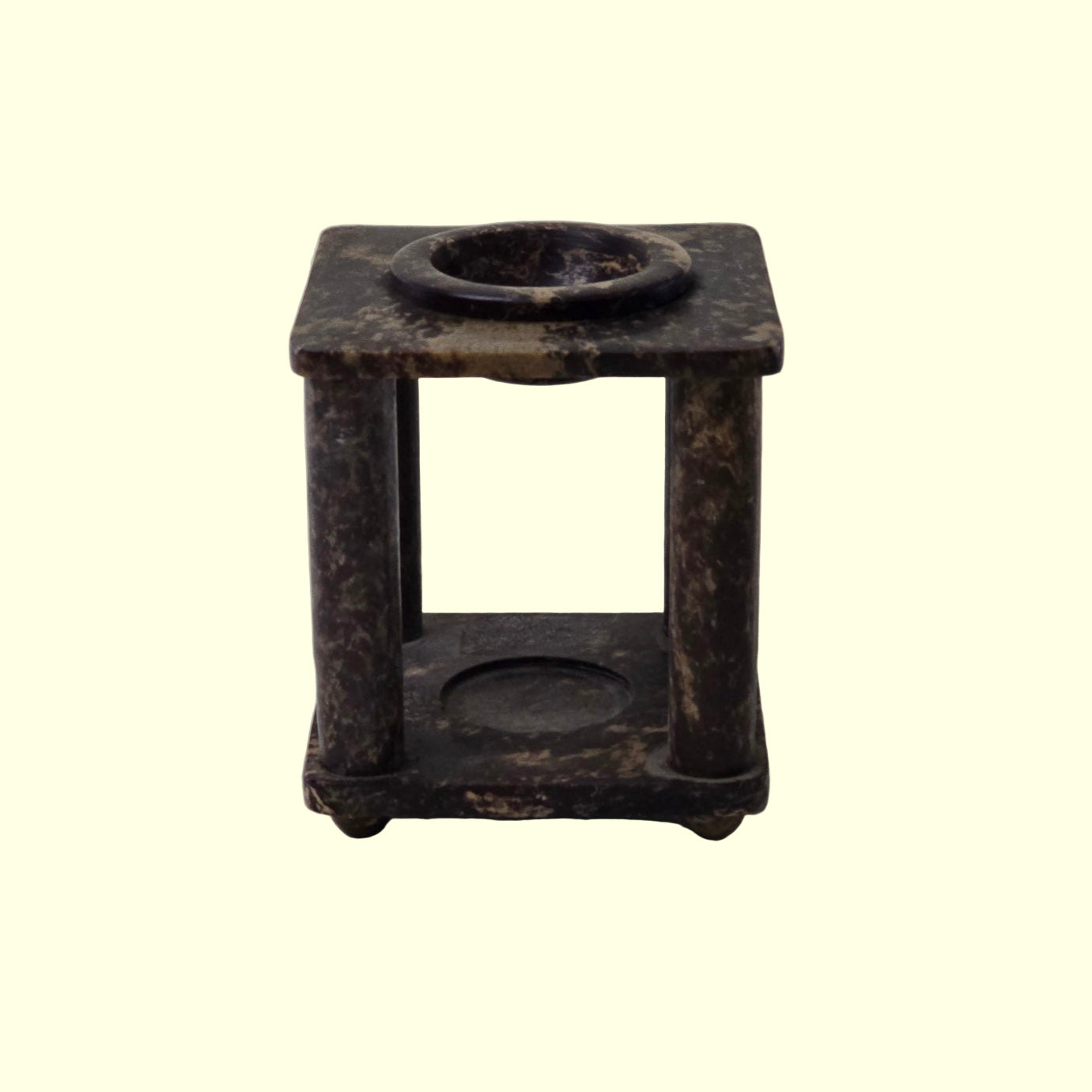 Rustic metal candle holder on a plain background