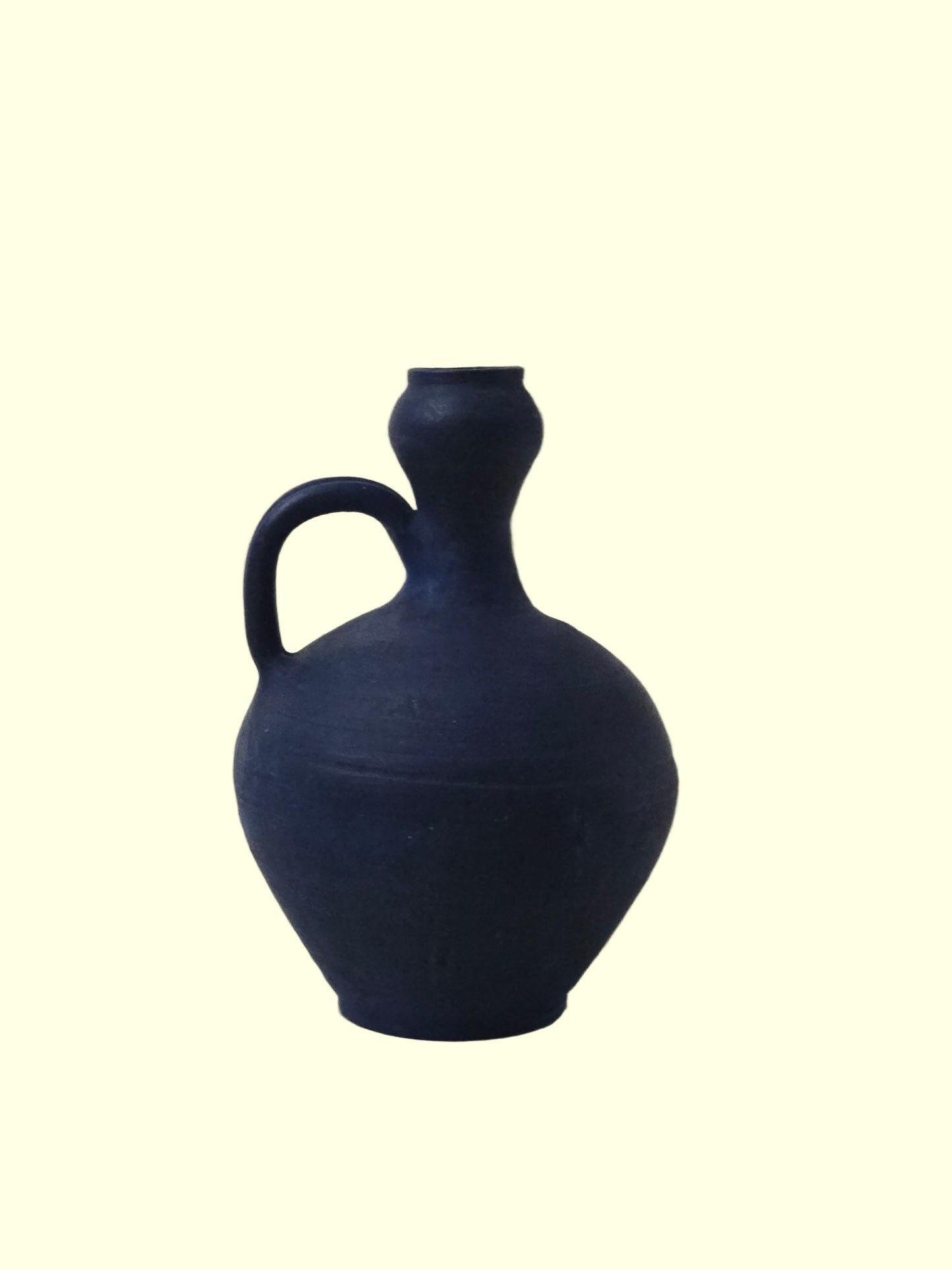 Blue ceramic jug on a light gray background