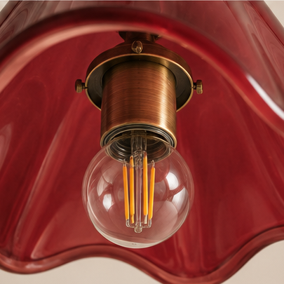 A vintage-style pendant light with a wavy, bell-shaped translucent red glass shade and an antique brass metal chain, socket, and cap. The image is a multi-view collage showing the full hanging lamp, close-ups of the top canopy, the glowing bulb inside, and the bottom socket.
