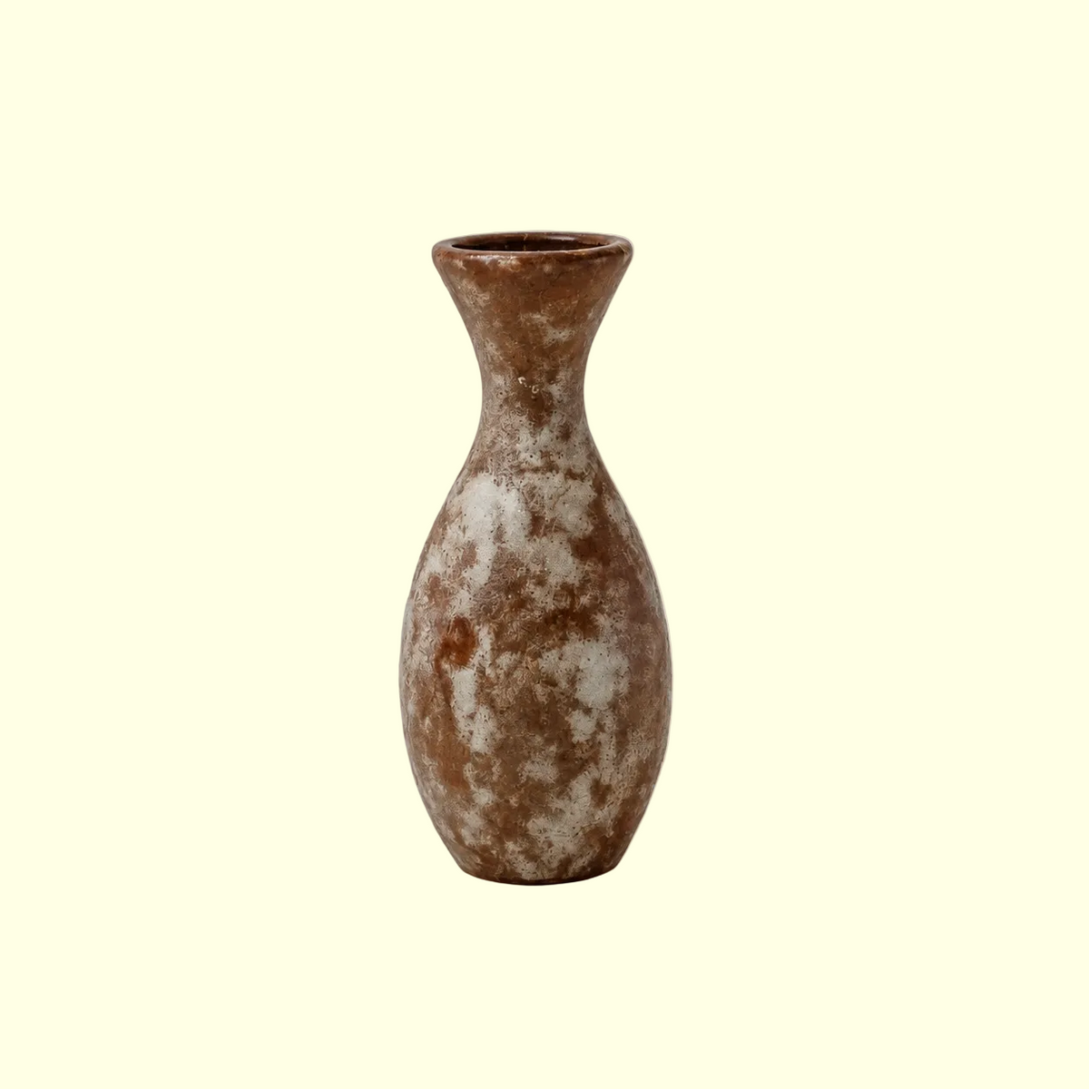 A small ceramic vase with a narrow neck and rounded body, featuring a mottled brown and off-white glaze, centered on a solid beige background.