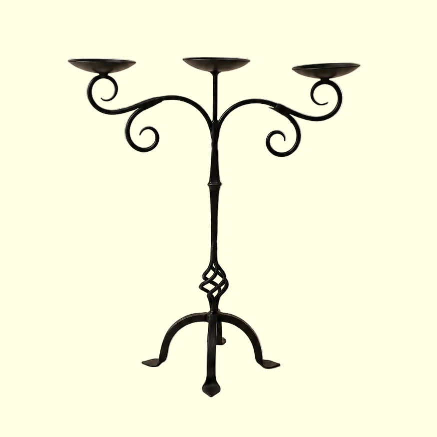 Black metal candelabra on a beige background
