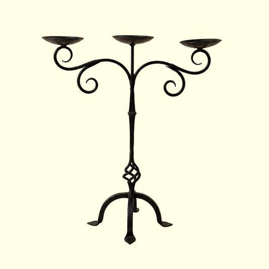 Black metal candelabra on a beige background